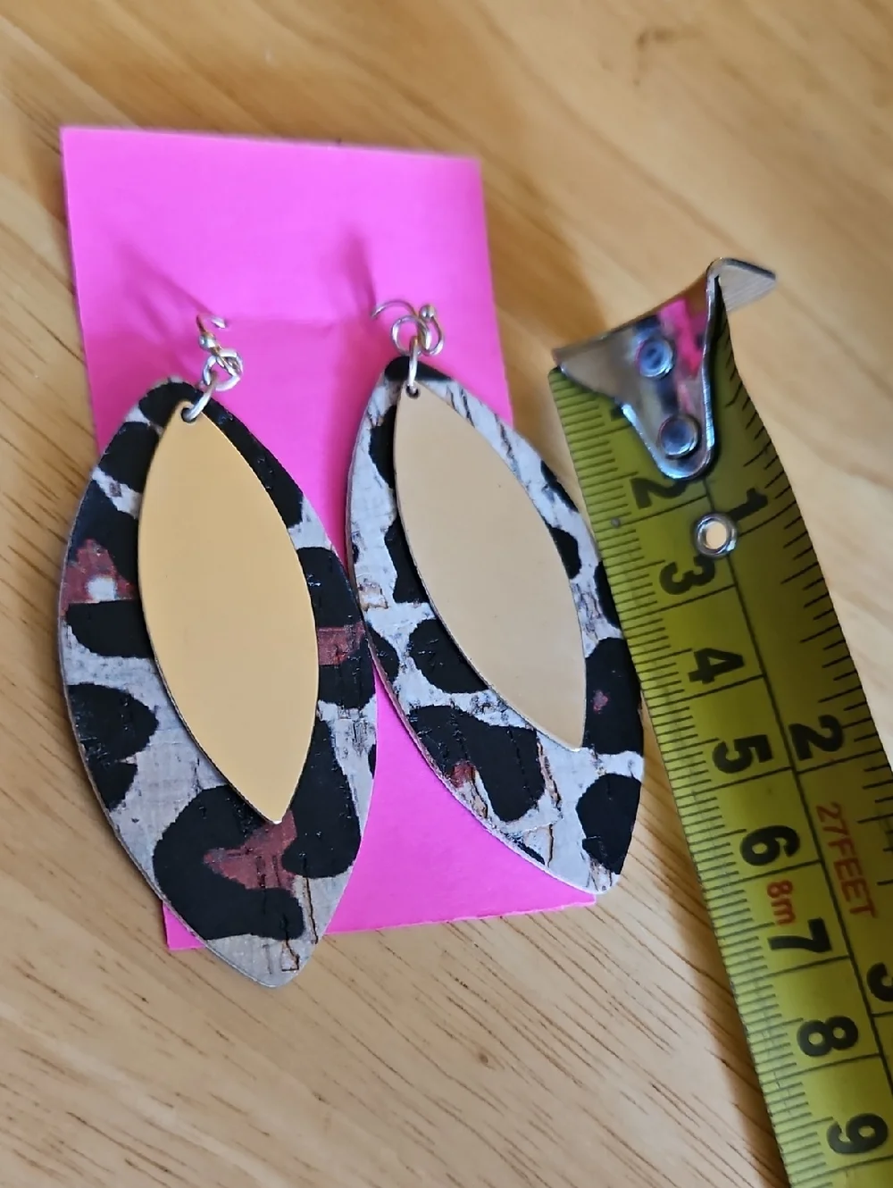 Layered leaf-shaped earrings w/ a leopard print backing and a gold metal top